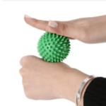 Green spiky massage ball for hand therapy, muscle relaxation, and pressure point relief – ideal for improving circulation and reducing tension.